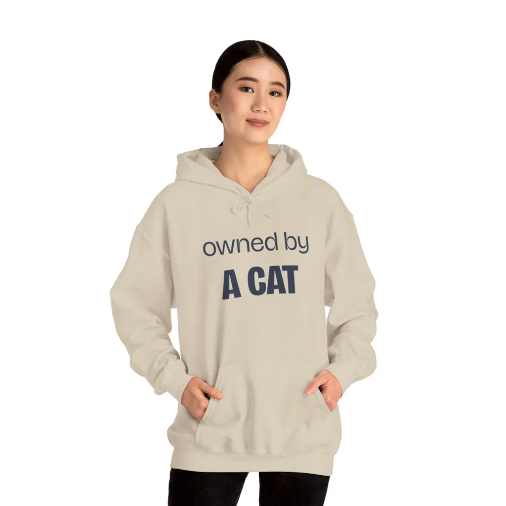 Model wearing the Owned by a cat lettering hoodie in Bone