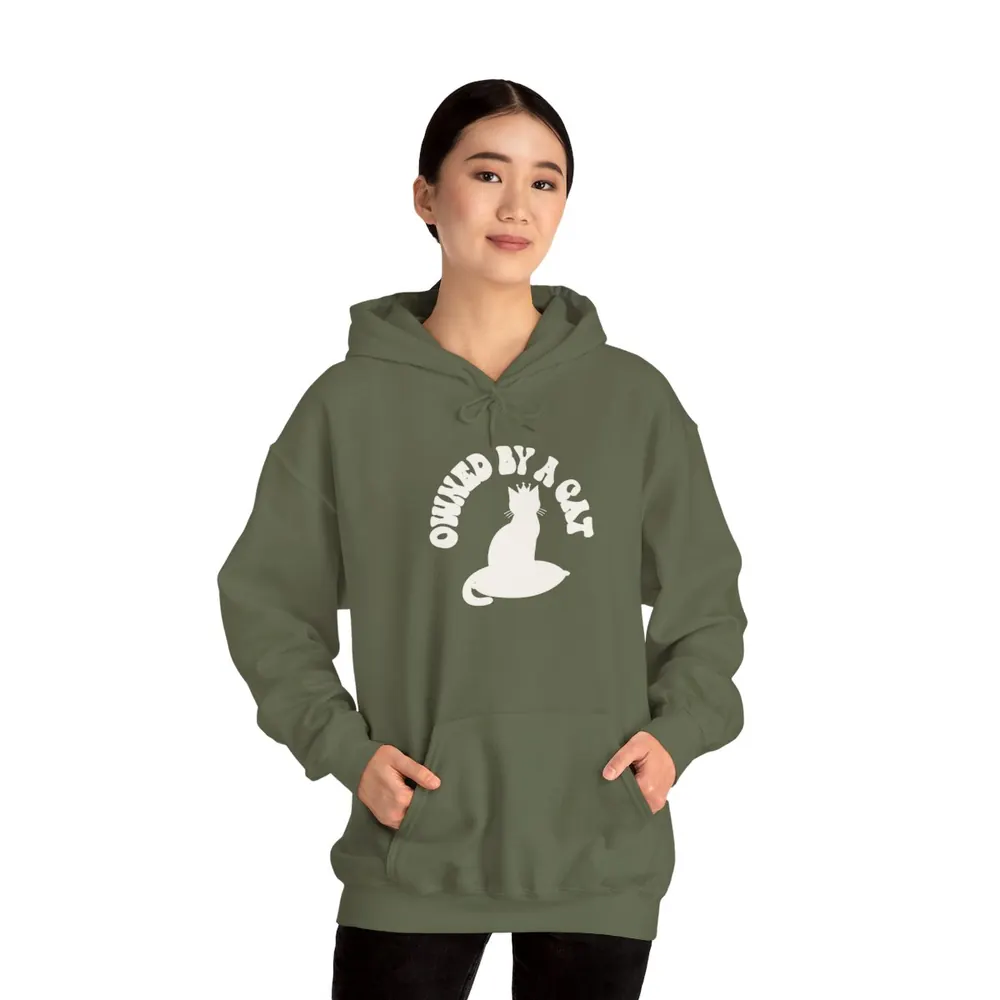 Model wearing the Owned by a cat crown hoodie in Moss